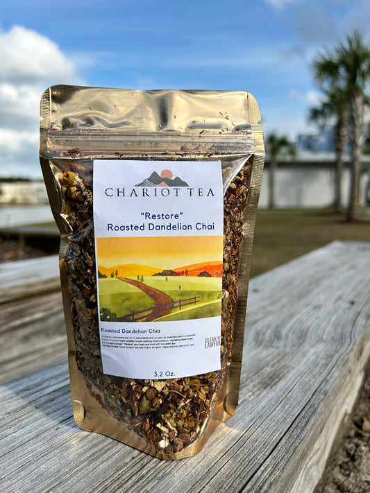 herbal dandelion chai tea sitting outside in the sun next to a lake and palm trees