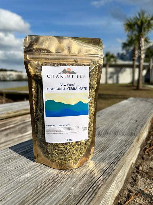 herbal tea sitting outside in the sunshine near a lake with palm trees